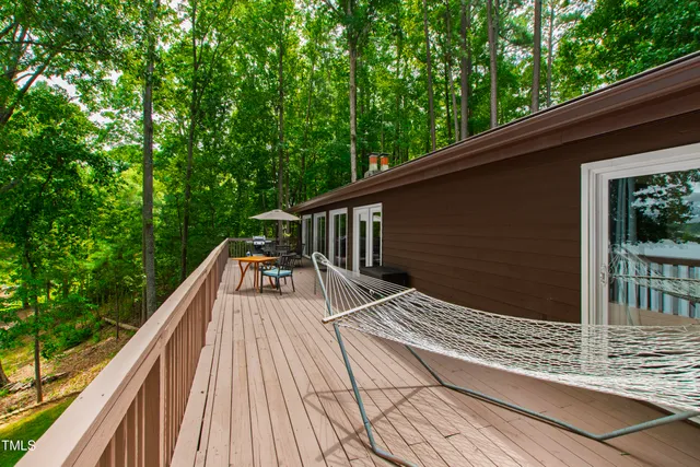 a backyard of a house with fountain table and chairs