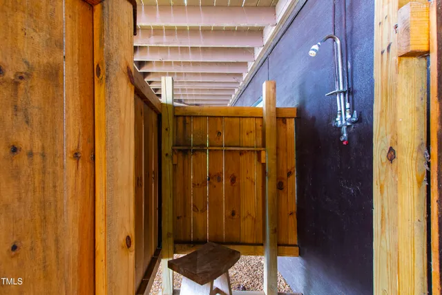 a view of a yard with wooden fence
