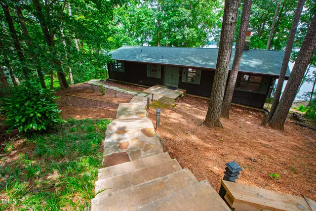 a view of a house with backyard and sitting area