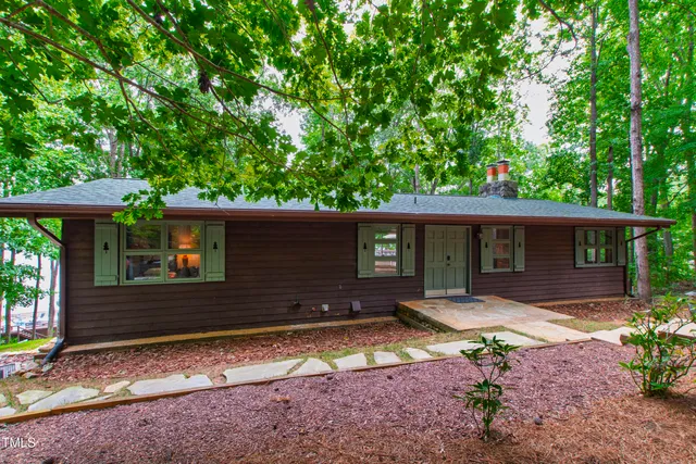 a backyard of a house with yard and outdoor seating