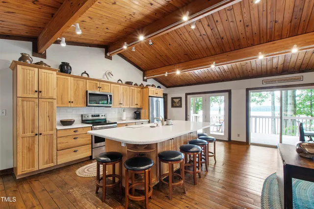 a large kitchen with a table and chairs in it