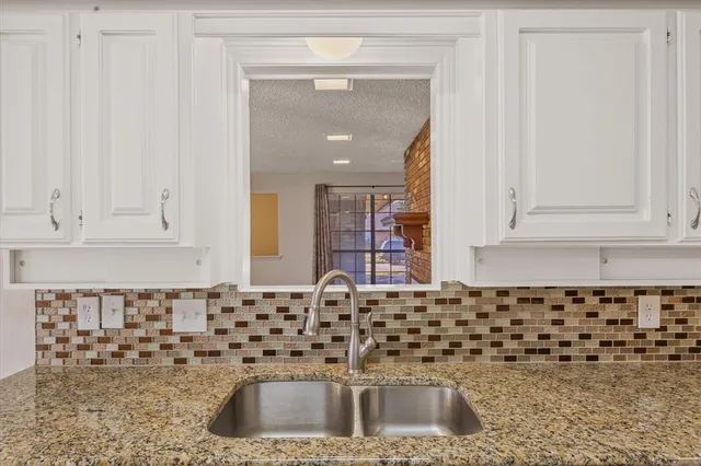 a kitchen with a sink and cabinets