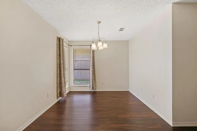a view of a room with wooden floor staircase and a hallway