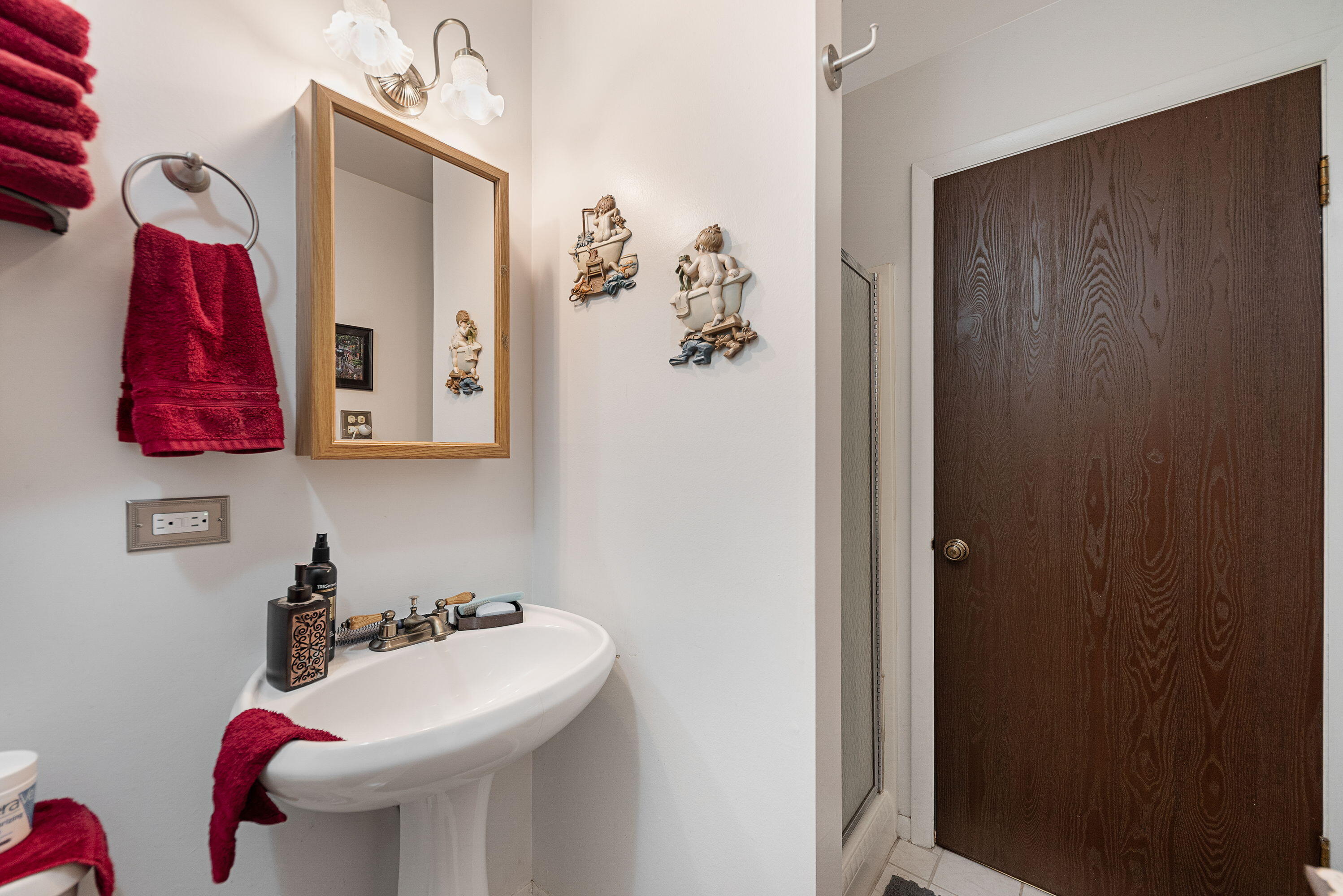 450 Old Stone Road, Unit 2 Munster, IN 46321 - Photo 14 of 16 a bathroom with a sink and mirror with toilet