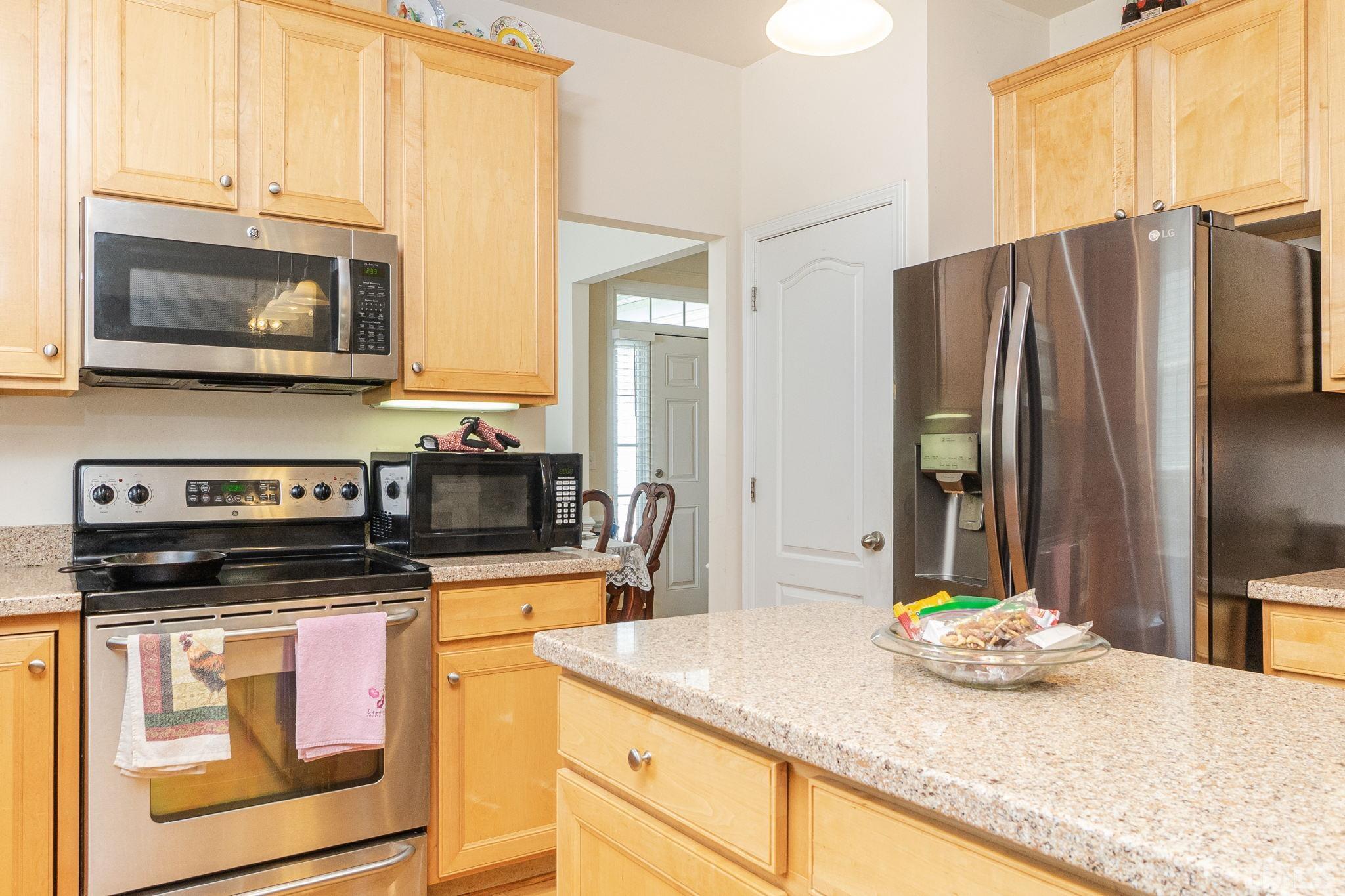 3404 Secretariat Way Raleigh, NC 27614 - Photo 15 of 44 a kitchen with granite countertop a stove and a microwave