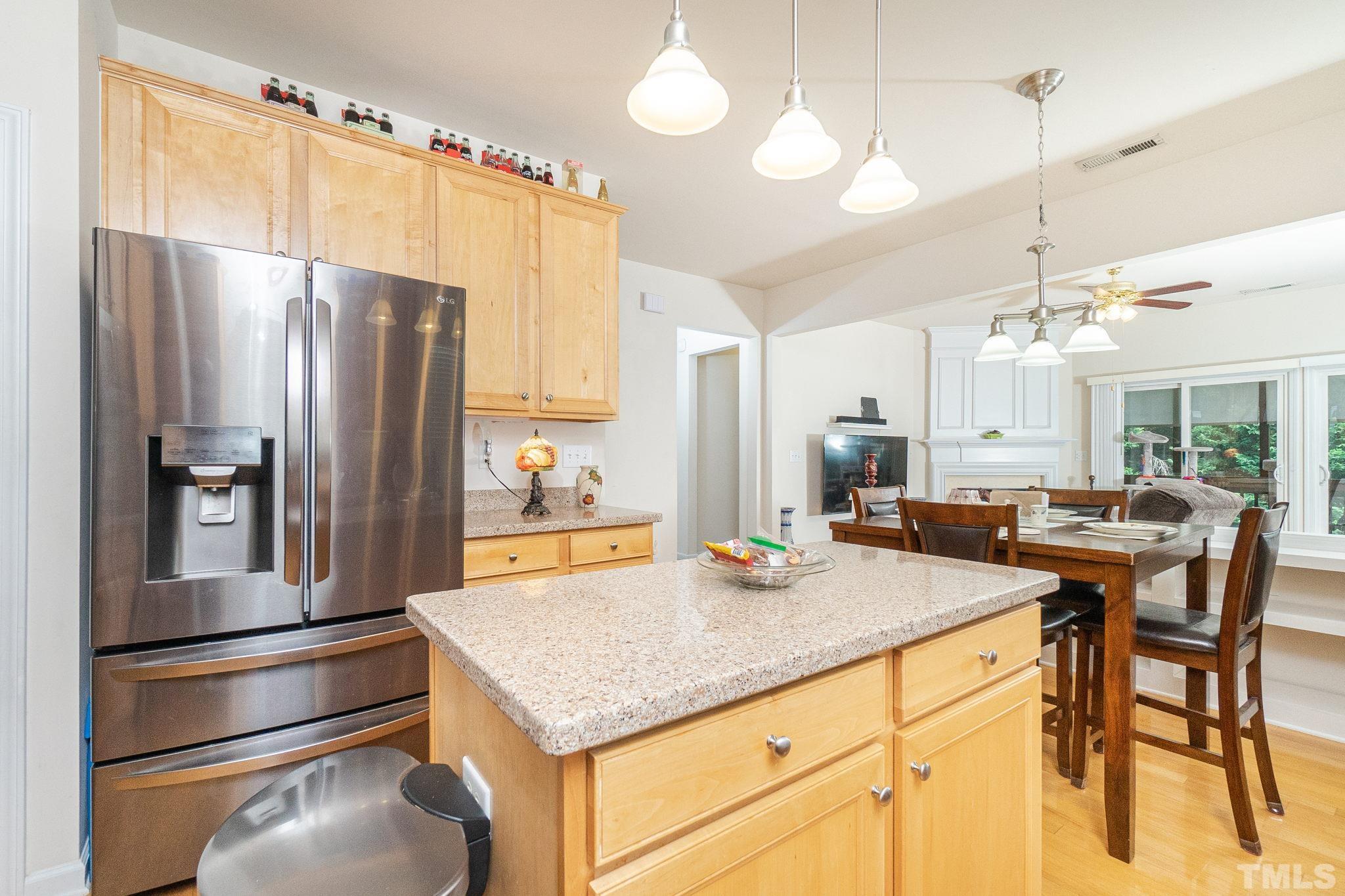 3404 Secretariat Way Raleigh, NC 27614 - Photo 17 of 44 a kitchen with kitchen island a counter top space appliances and cabinets
