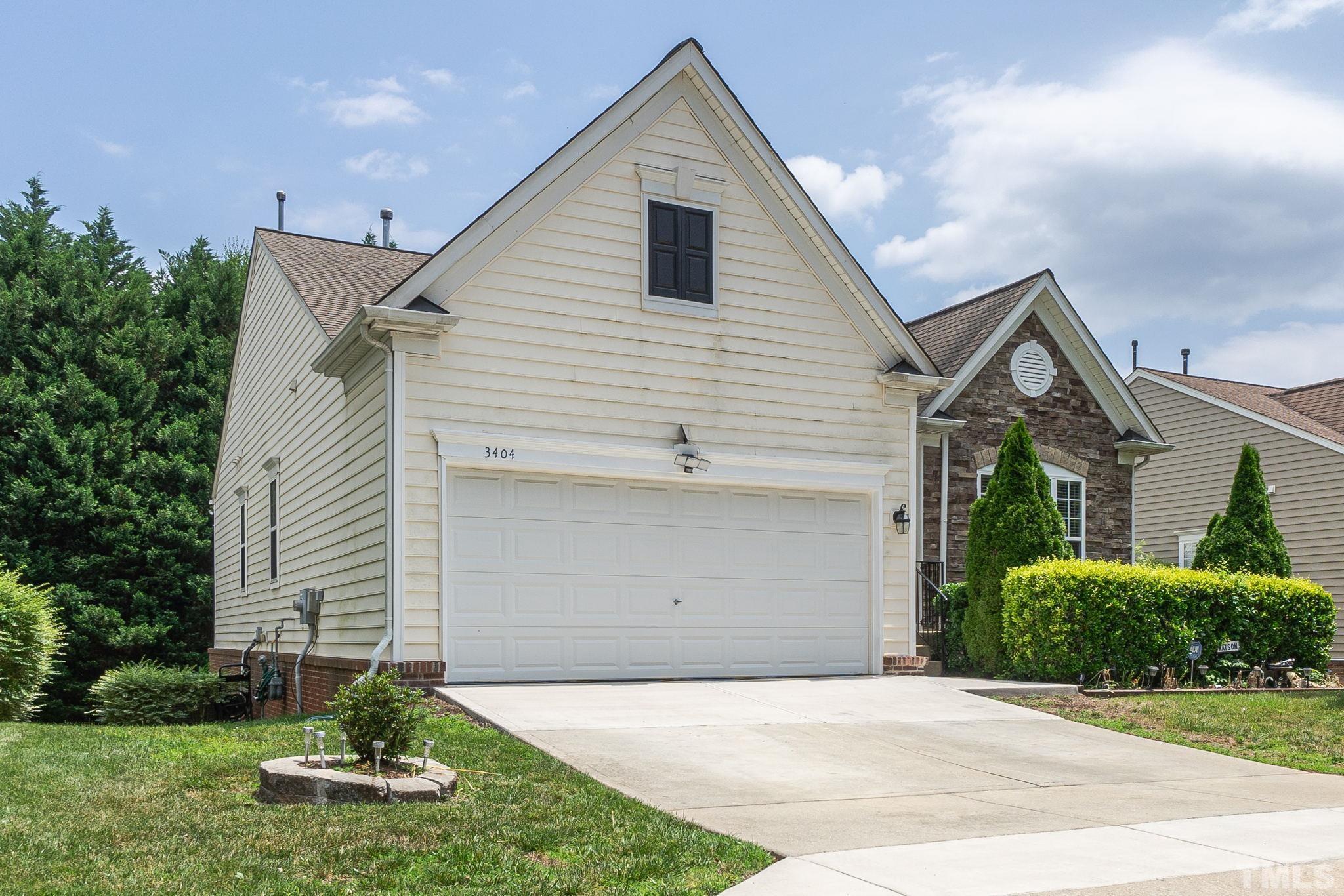 3404 Secretariat Way Raleigh, NC 27614 - Photo 2 of 44 a front view of a house with a yard and garage