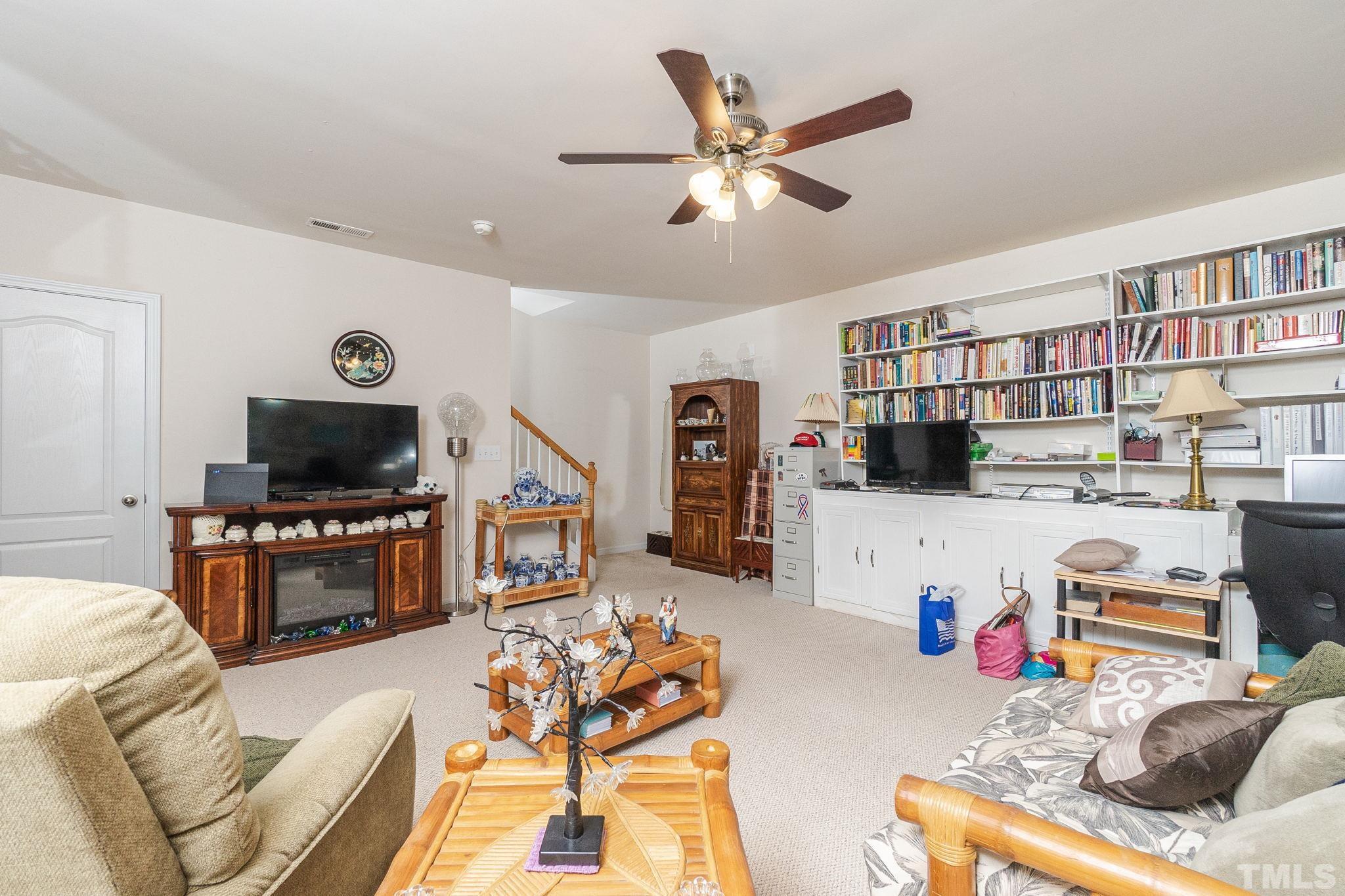 3404 Secretariat Way Raleigh, NC 27614 - Photo 33 of 44 a living room with furniture and a flat screen tv