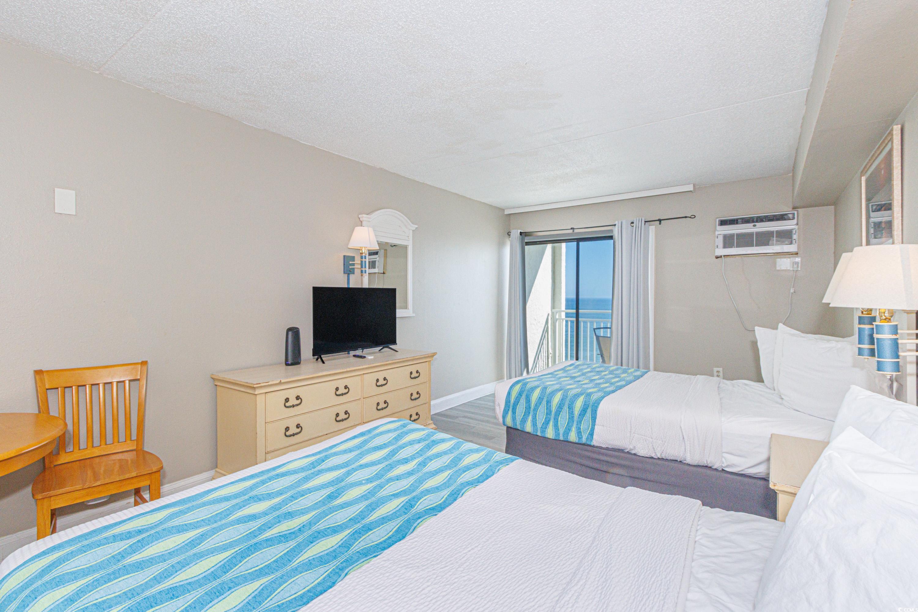 1207 South Ocean Boulevard, Unit 20703 Myrtle Beach, SC 29577 - Photo 13 of 22 Bedroom with wood-type flooring and an AC wall unit
