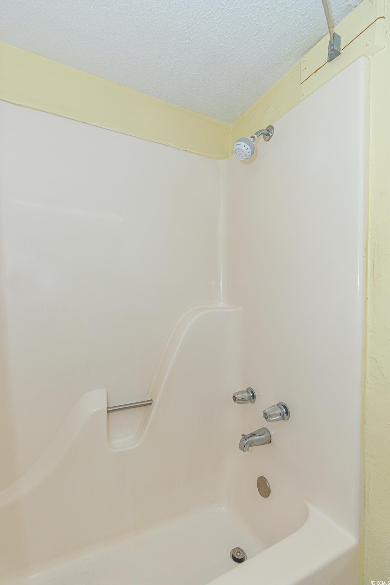 1207 South Ocean Boulevard, Unit 20703 Myrtle Beach, SC 29577 - Photo 17 of 22 Bathroom featuring a textured ceiling and bathtub / shower combination