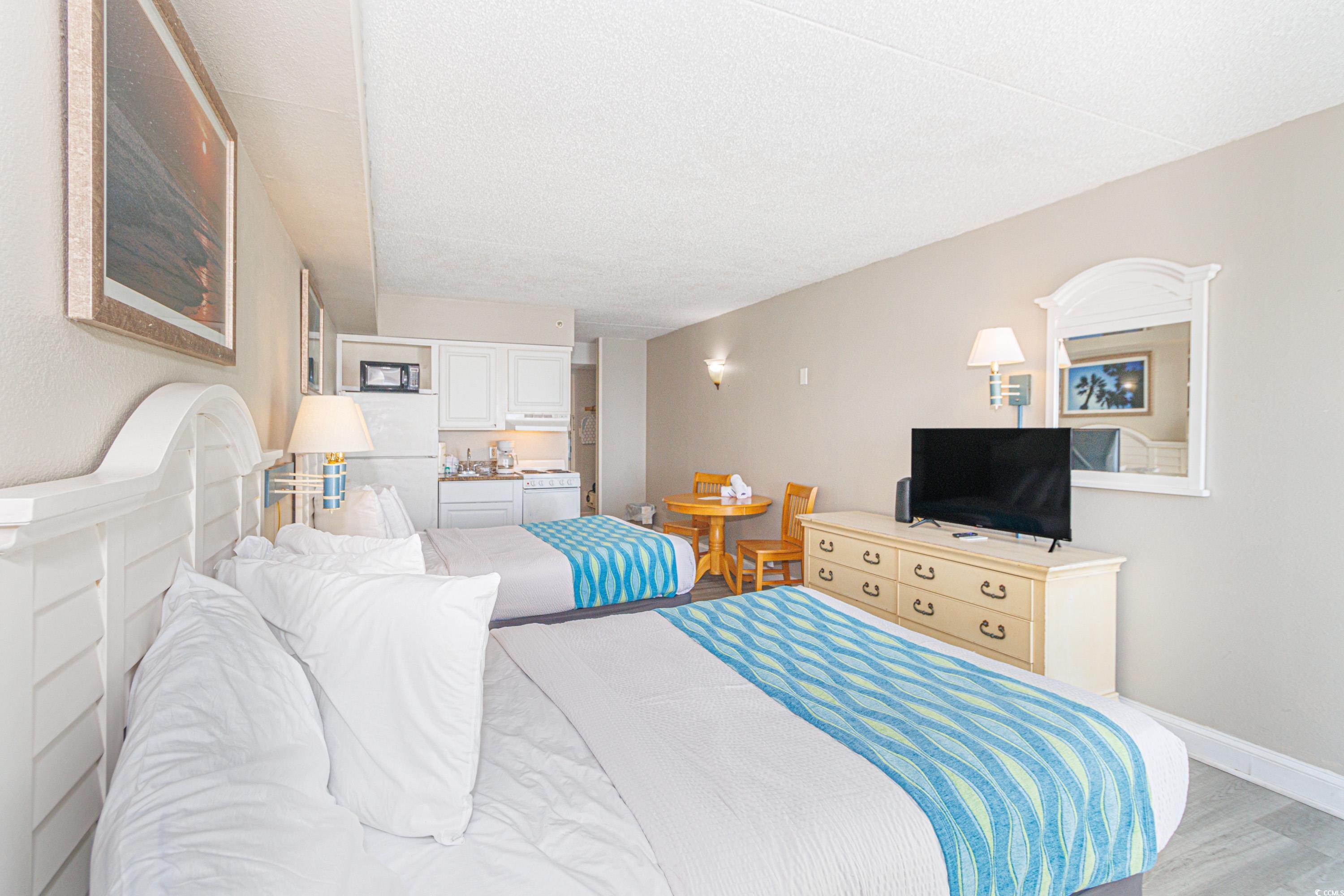 1207 South Ocean Boulevard, Unit 20703 Myrtle Beach, SC 29577 - Photo 8 of 22 Bedroom with a textured ceiling and light wood-type flooring