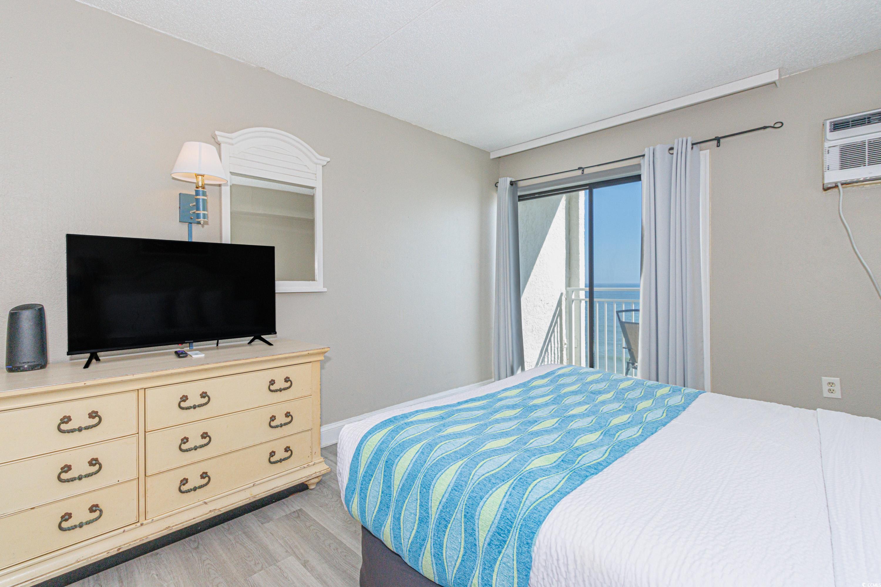 1207 South Ocean Boulevard, Unit 20703 Myrtle Beach, SC 29577 - Photo 10 of 22 Bedroom with access to outside and light hardwood / wood-style flooring