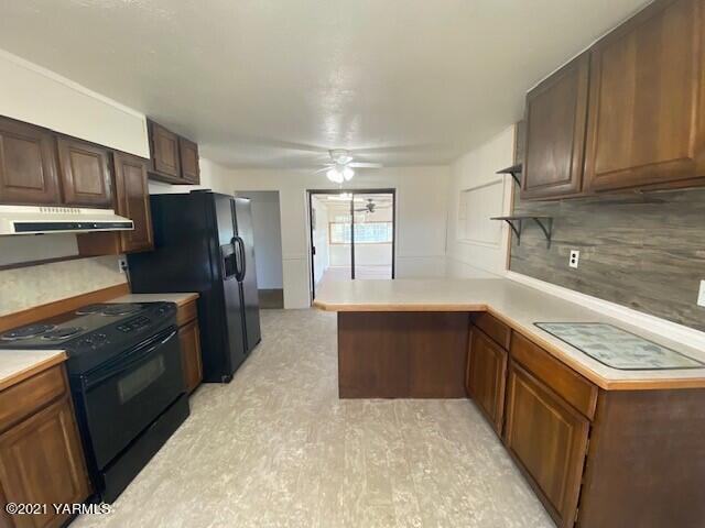 320 Lower County Line Road Prosser, WA 99350 - Photo 7 of 14 a kitchen with stainless steel appliances granite countertop a refrigerator stove and sink