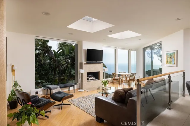 a living room with fireplace furniture and a large window