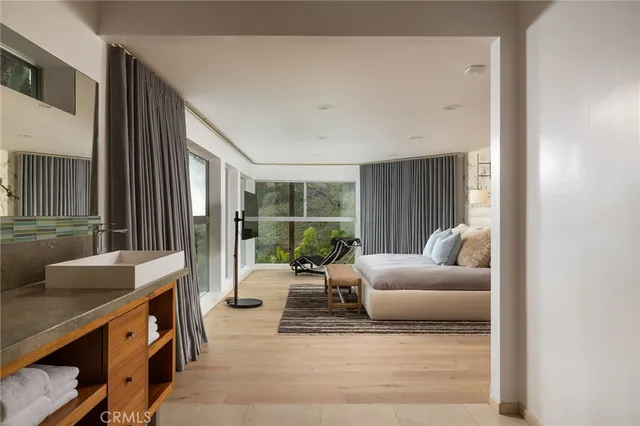 a bedroom with a bed and wooden floor