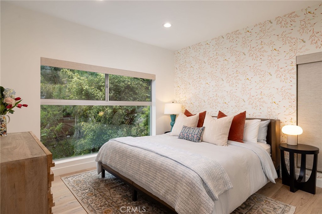 865 Balboa Avenue Laguna Beach, CA 92651 - Photo 21 of 60 a bedroom with a bed lamp and a large window