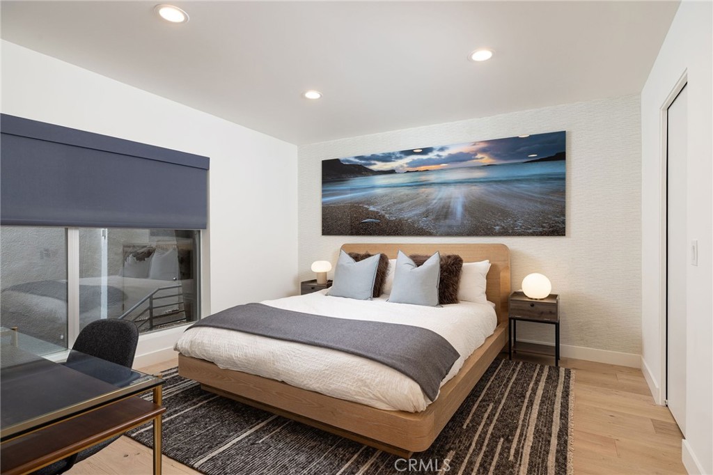 865 Balboa Avenue Laguna Beach, CA 92651 - Photo 23 of 60 a bedroom with a bed and glass door