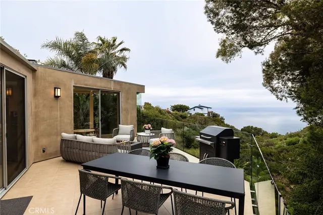 a view of a balcony with table and chairs