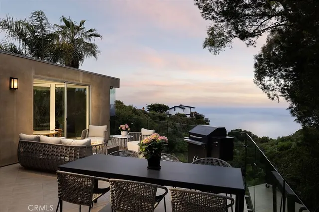 a view of a balcony with table and chairs and a potted plant