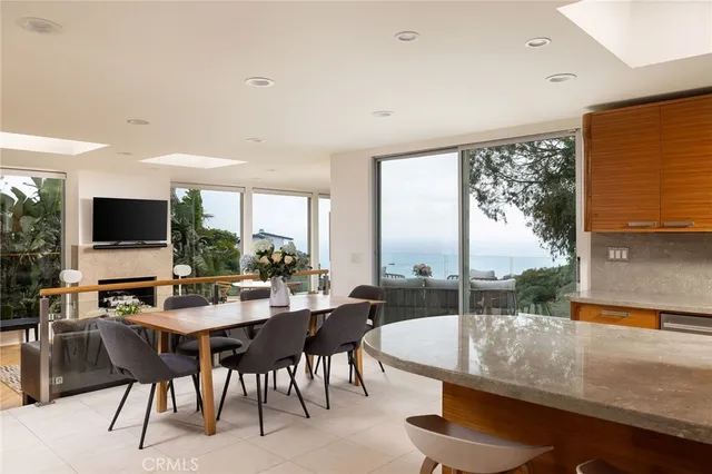 a dining room with furniture and a flat screen tv