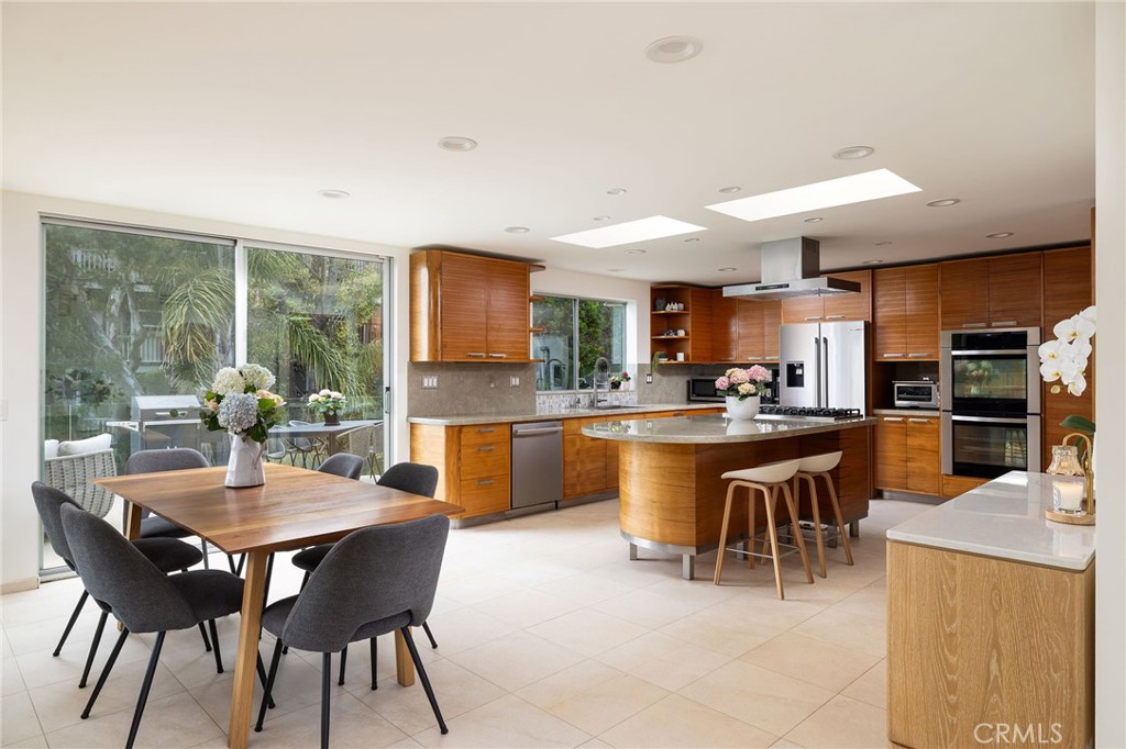 865 Balboa Avenue Laguna Beach, CA 92651 - Photo 6 of 60 a dining area with a table chairs and flat screen tv