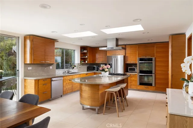 a kitchen with stainless steel appliances granite countertop a stove and a refrigerator