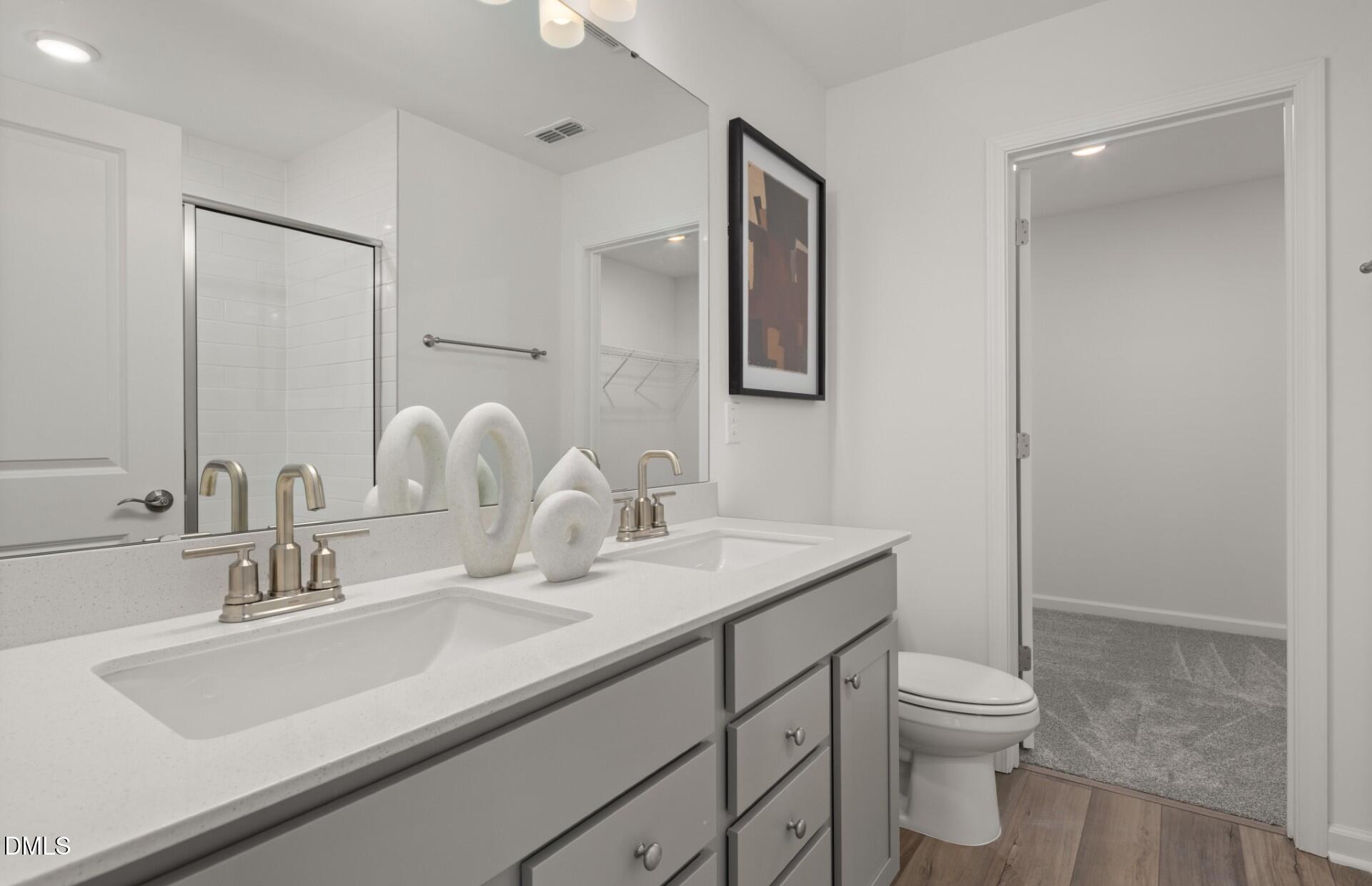 605 Timber Terrace Drive Durham, NC 27704 - Photo 18 of 31 a bathroom with a sink toilet and mirror