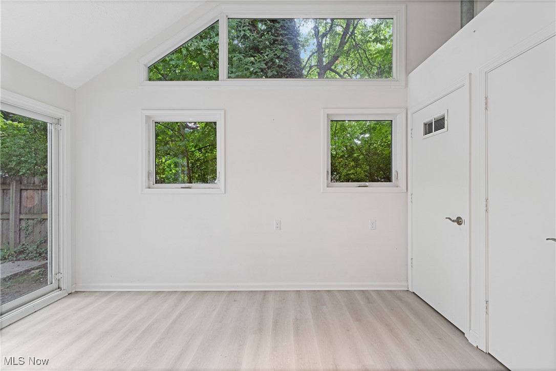 1057 Renfield Road Cleveland Heights, OH 44121 - Photo 14 of 30 Spare room with high vaulted ceiling and light hardwood / wood-style floors