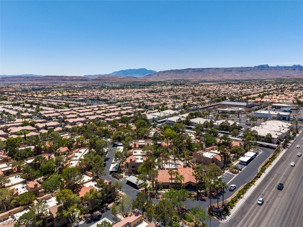 9325 West Desert Inn Road, Unit 244 Las Vegas, NV 89117 - Photo 48 of 55 An aerial perspective reveals a sprawling residential community set against a backdrop of distant mountains.