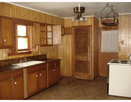 a bathroom with a granite countertop sink a mirror a vanity and a shower