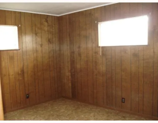 a view of a small space with a wooden door