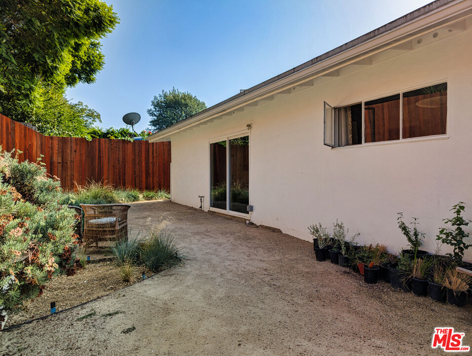 1237 Montecito Drive Los Angeles, CA 90031 - Photo 17 of 26 a view of a backyard with potted plants and wooden fence