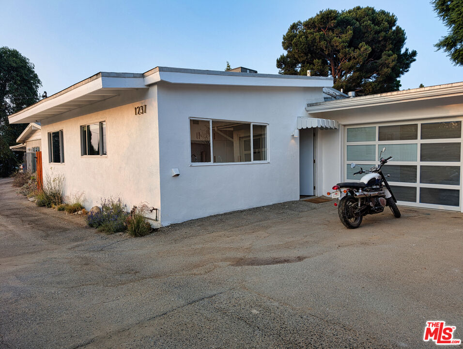 1237 Montecito Drive Los Angeles, CA 90031 - Photo 20 of 26 a view of a house with large windows and a small yard