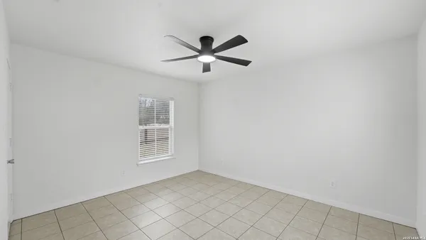 a view of a livingroom with a ceiling fan and window
