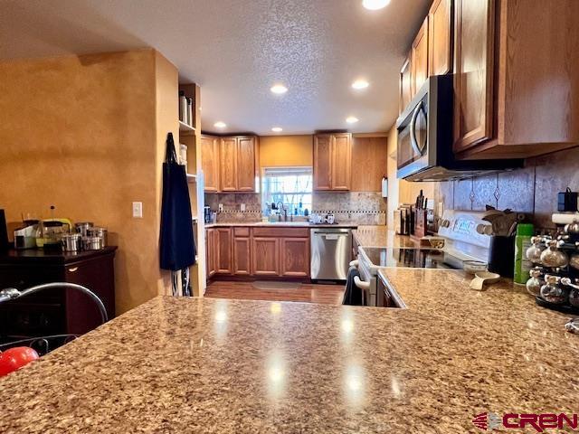 5255 Oviatt Street Mosca, CO 81146 - Photo 8 of 10 a kitchen with stainless steel appliances granite countertop a refrigerator a stove top oven a sink and dishwasher