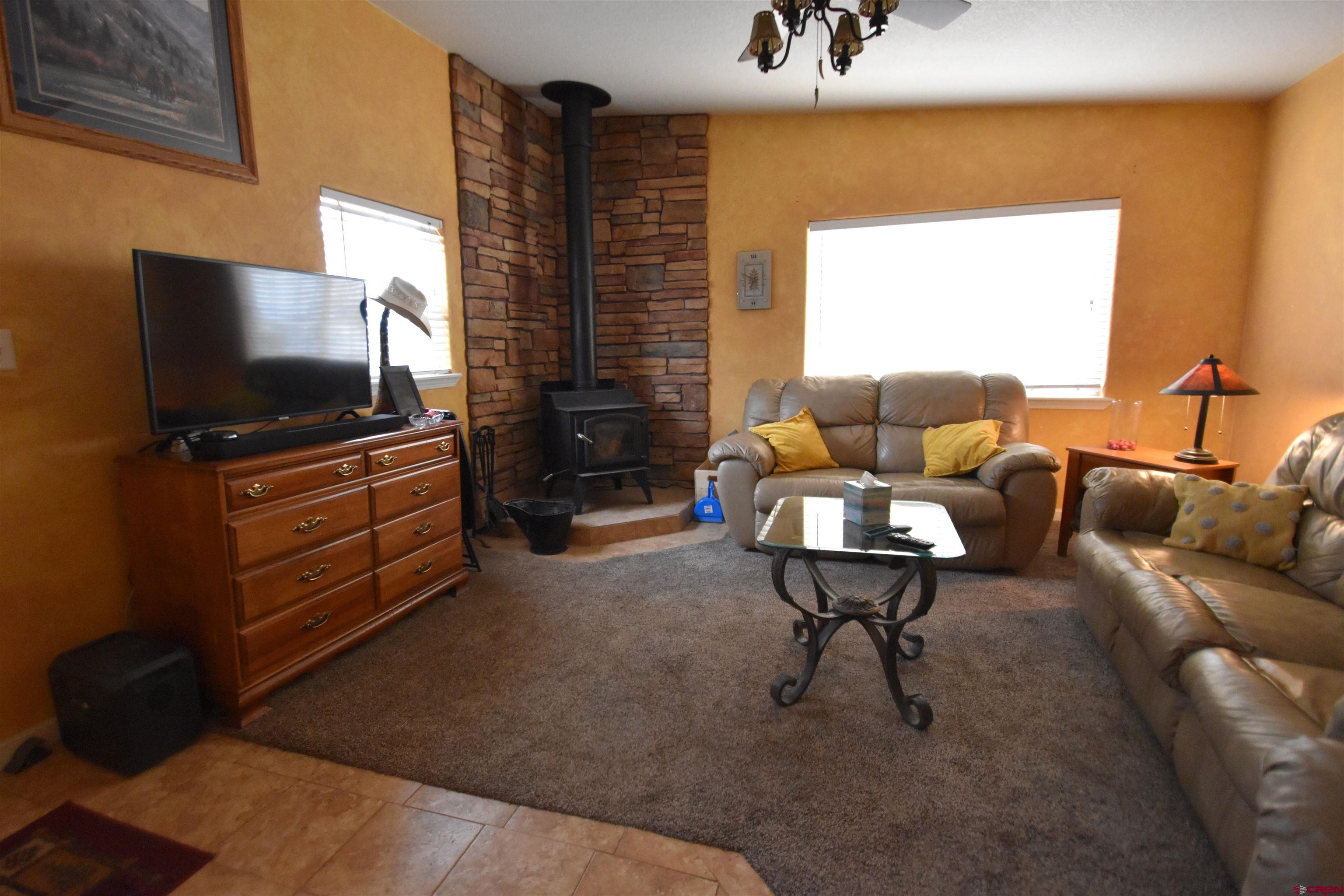 5255 Oviatt Street Mosca, CO 81146 - Photo 9 of 10 a living room with furniture and a flat screen tv