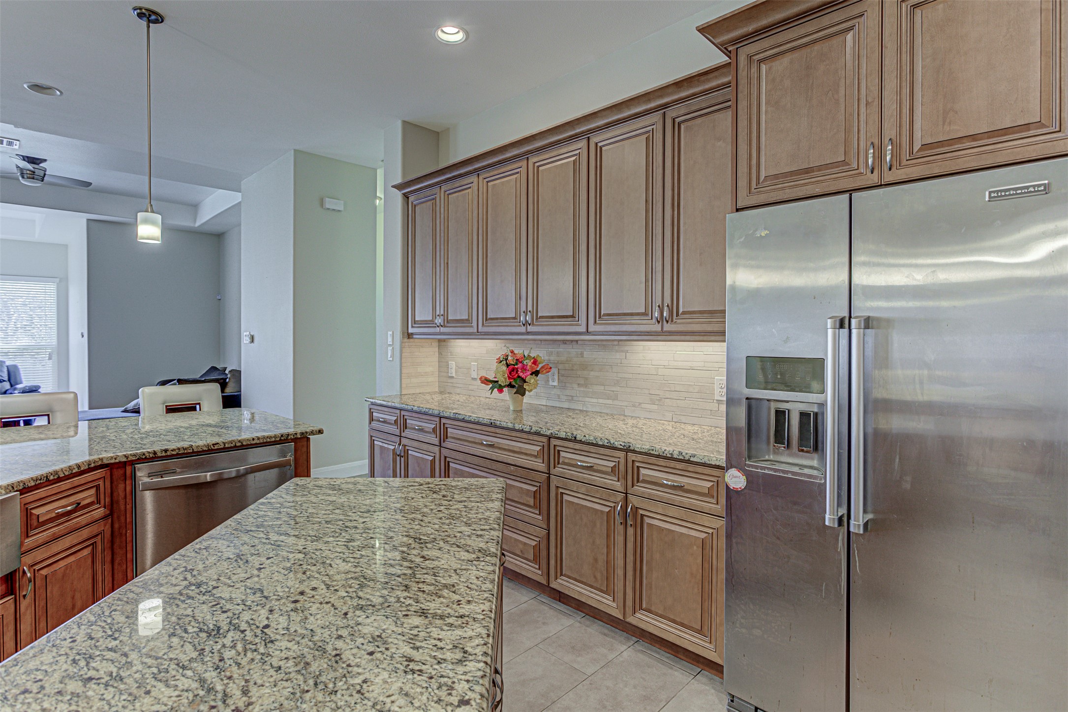 105 Arbors Circle Elgin, TX 78621 - Photo 17 of 40 Kitchen featuring stainless steel appliances, light stone countertops, and wood finish cabinetry