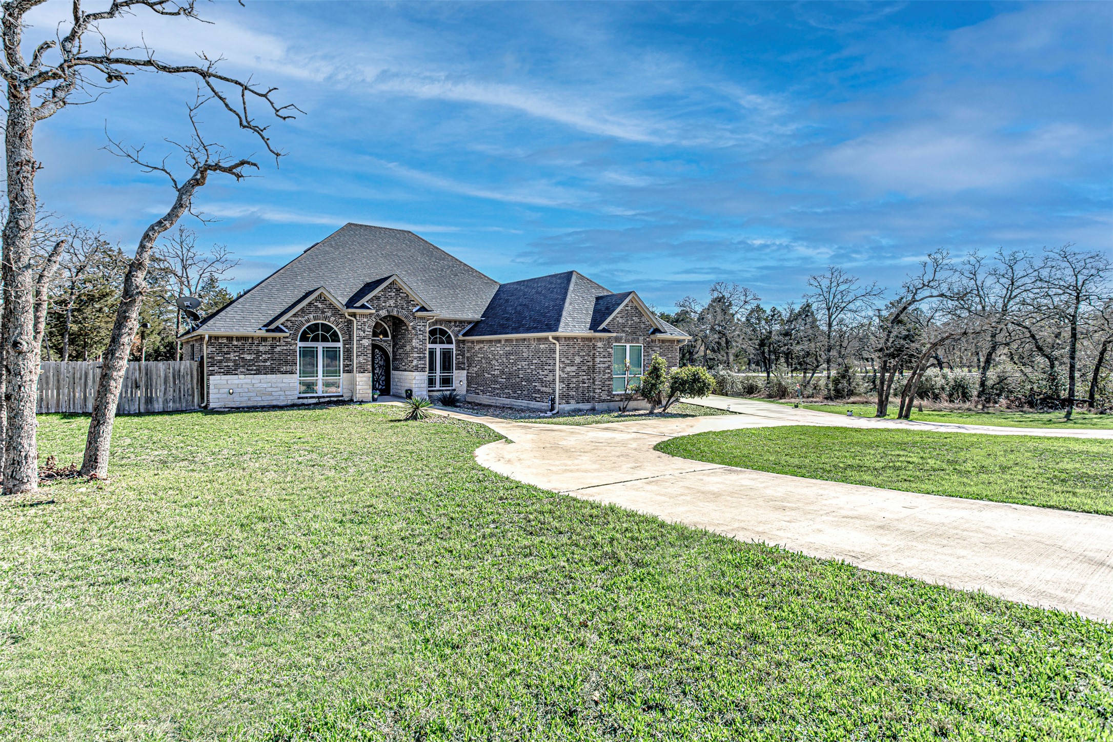 105 Arbors Circle Elgin, TX 78621 - Photo 2 of 40 French provincial home featuring driveway, brick siding, and a shingled roof