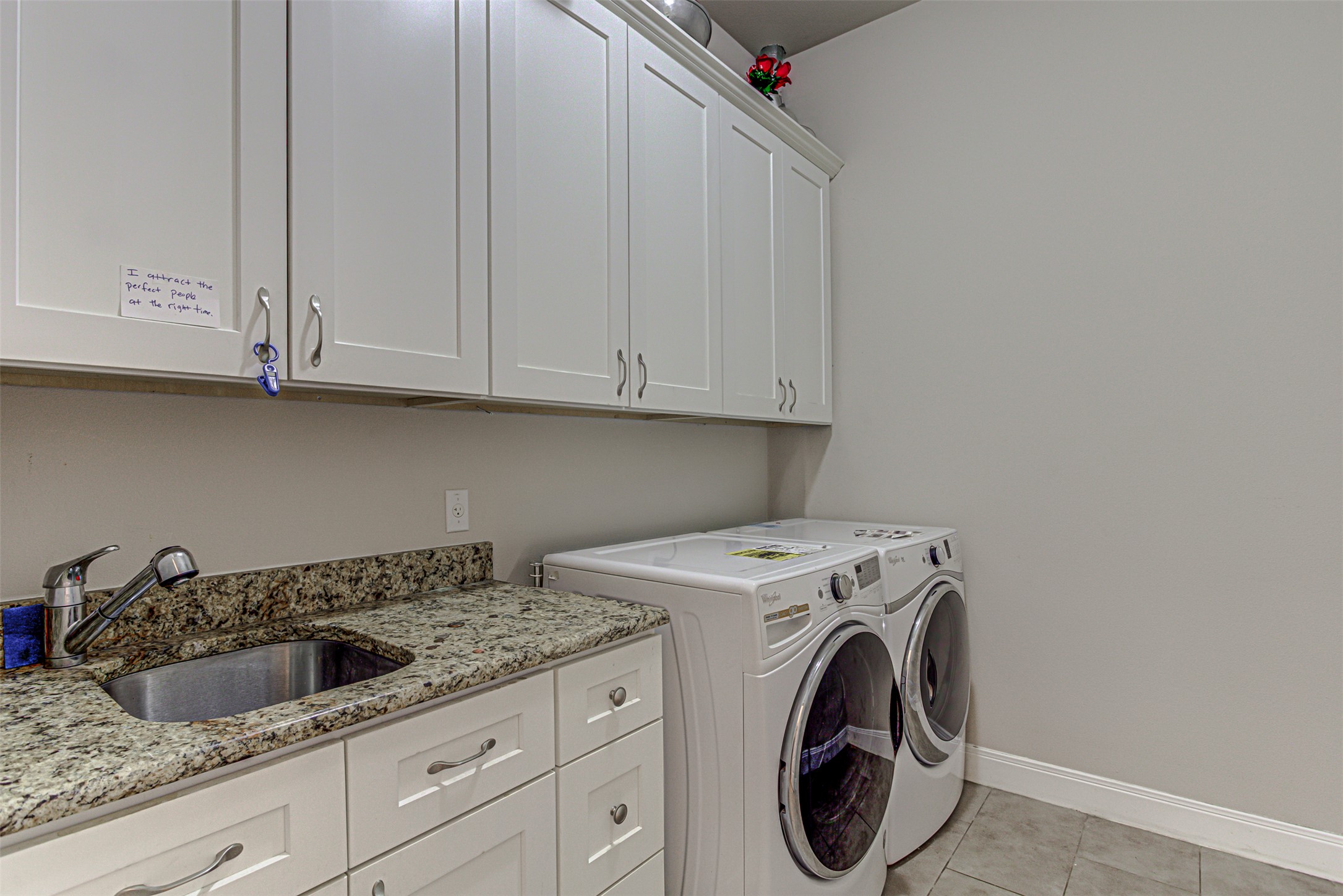 105 Arbors Circle Elgin, TX 78621 - Photo 24 of 40 Laundry room with independent washer and dryer, cabinet space, and light tile patterned floors