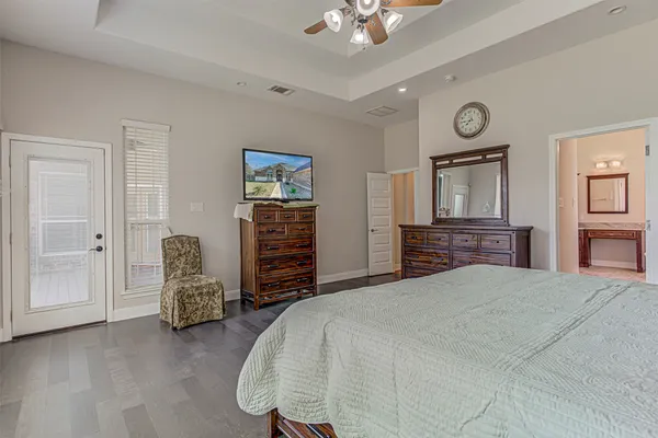 a bedroom with a bed and a chandelier