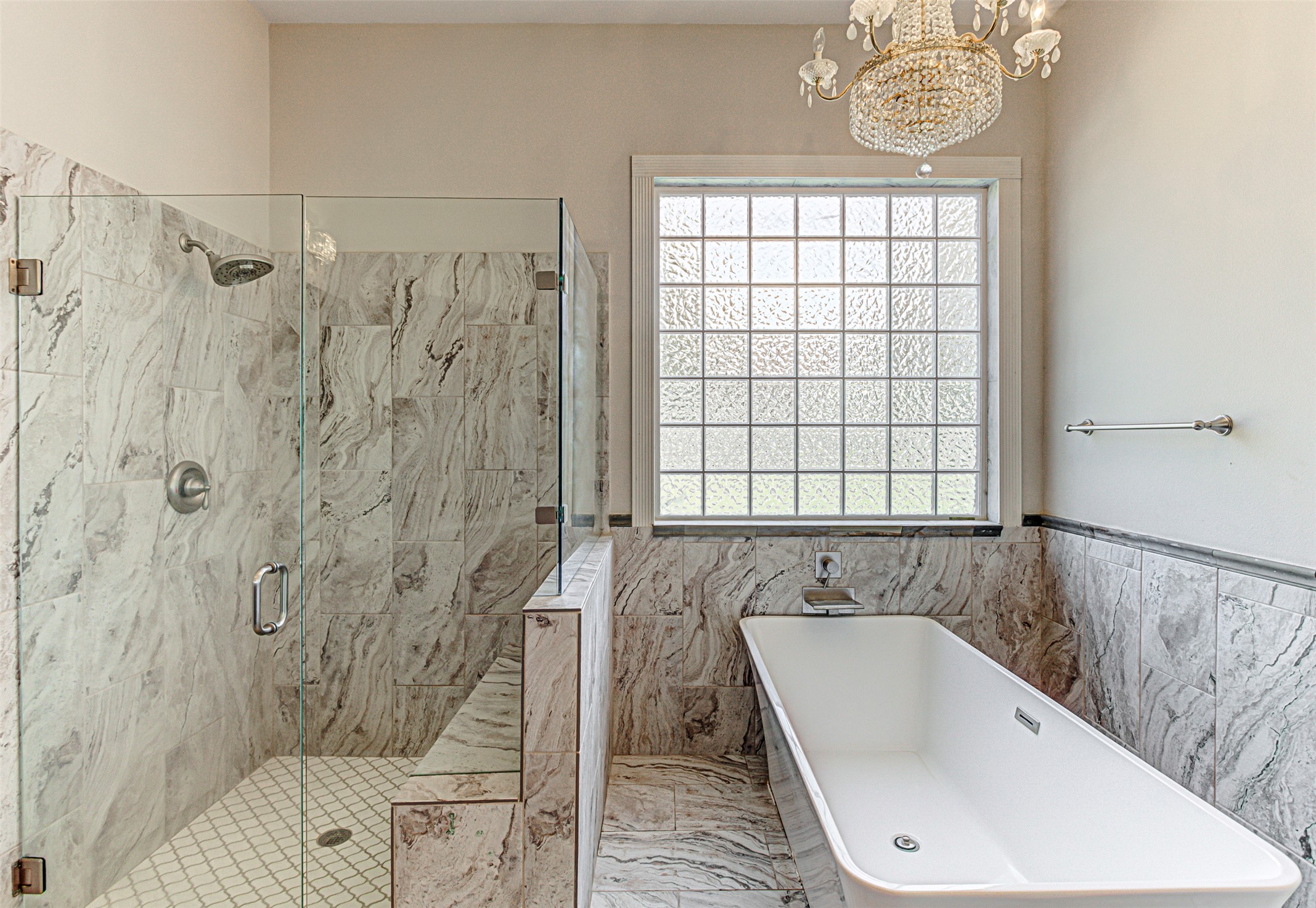 105 Arbors Circle Elgin, TX 78621 - Photo 30 of 40 Bathroom with hanging lights, plenty of natural light, a marble finish shower, and a freestanding tub