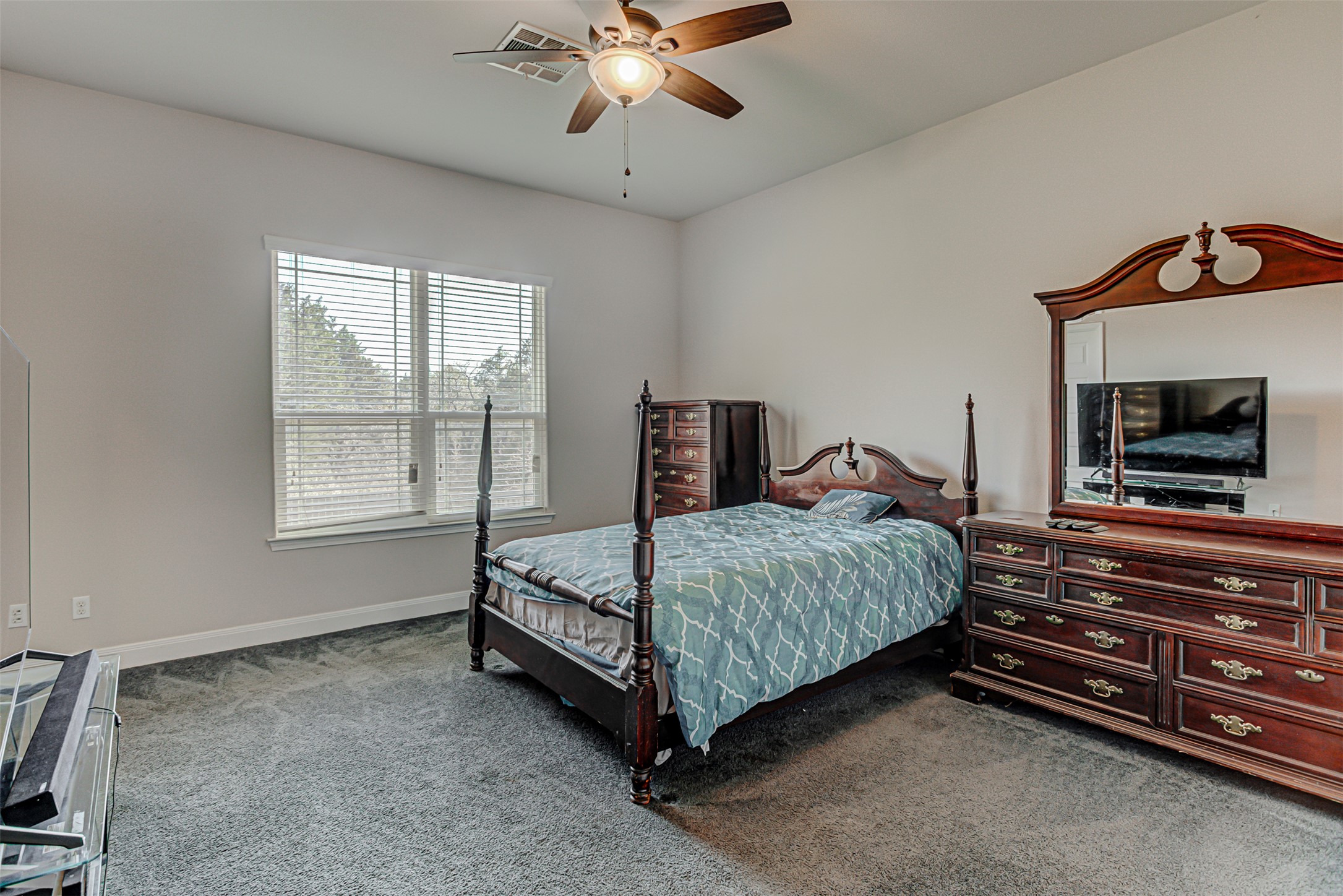 105 Arbors Circle Elgin, TX 78621 - Photo 31 of 40 Bedroom featuring dark colored carpet and a ceiling fan