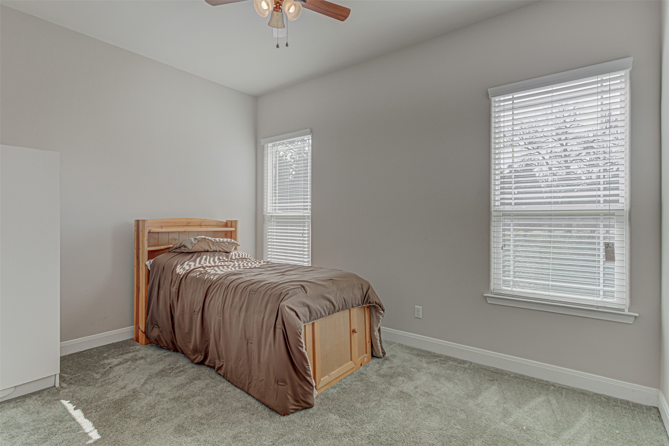 105 Arbors Circle Elgin, TX 78621 - Photo 33 of 40 Bedroom featuring ceiling fan and light carpet