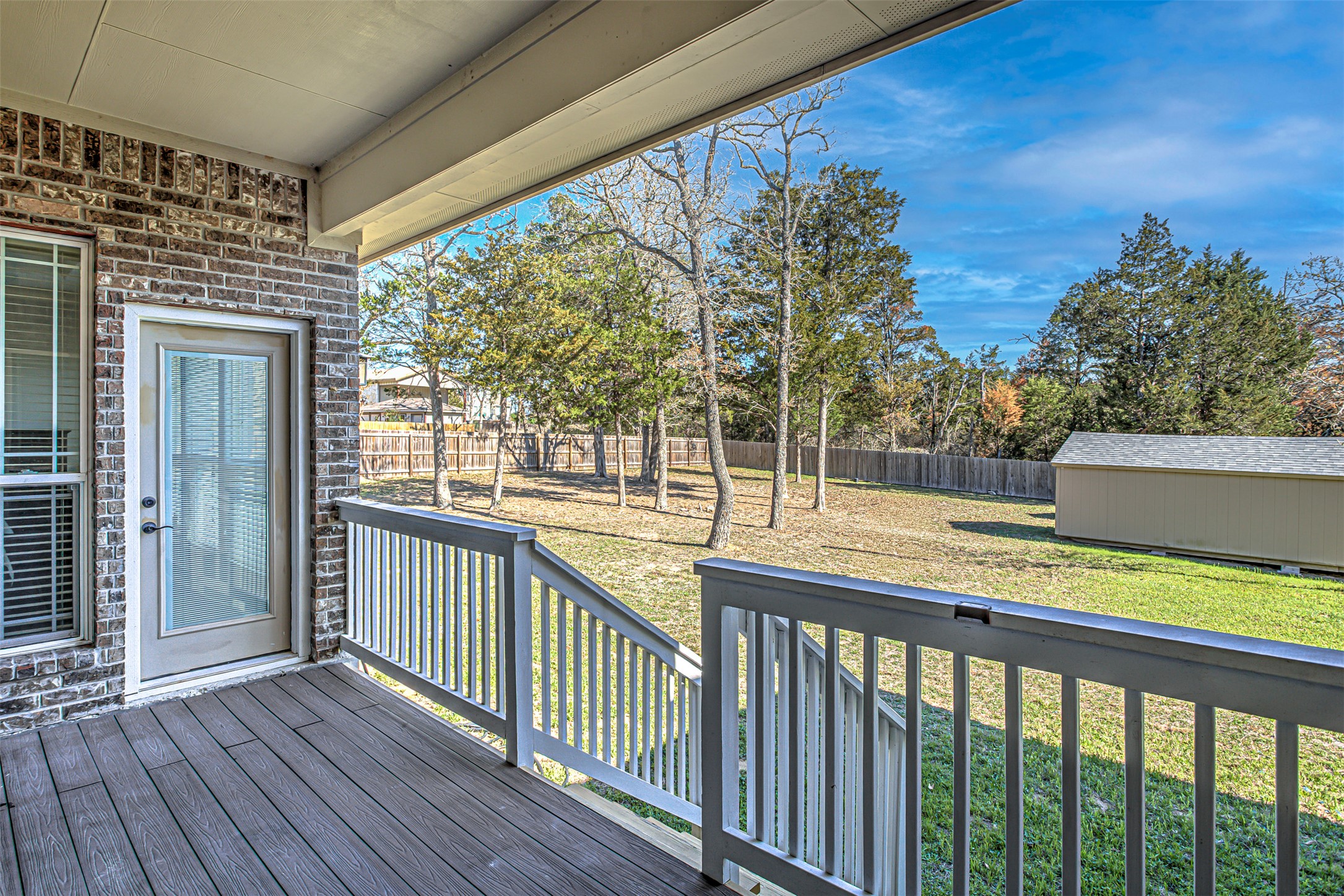 105 Arbors Circle Elgin, TX 78621 - Photo 37 of 40 Wooden terrace featuring a fenced backyard, a storage shed, and a playground