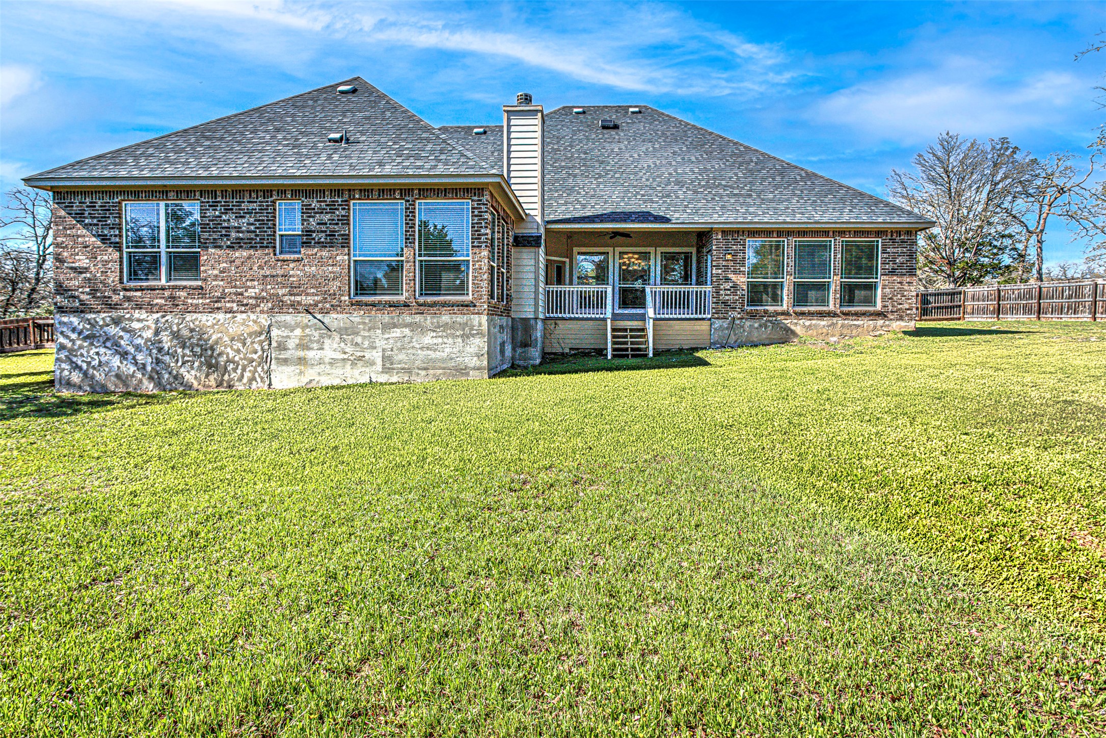 105 Arbors Circle Elgin, TX 78621 - Photo 38 of 40 Back of house featuring brick siding, a chimney, a patio, and a shingled roof