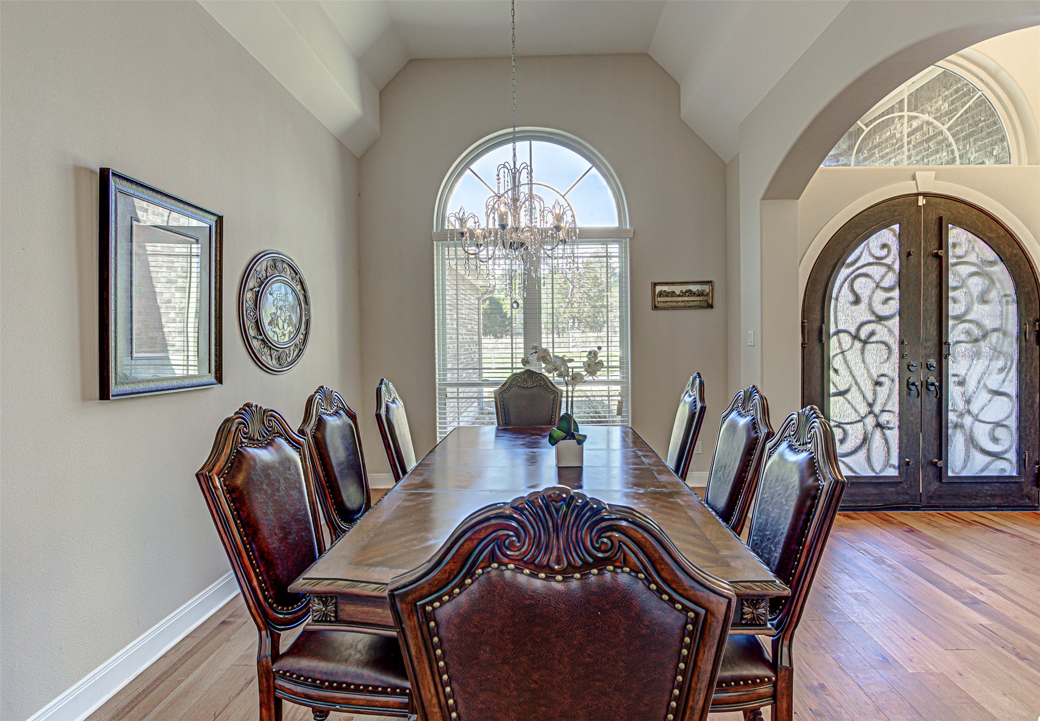 105 Arbors Circle Elgin, TX 78621 - Photo 5 of 40 Dining room with french doors, a chandelier, arched walkways, lofted ceiling, and light wood-type flooring
