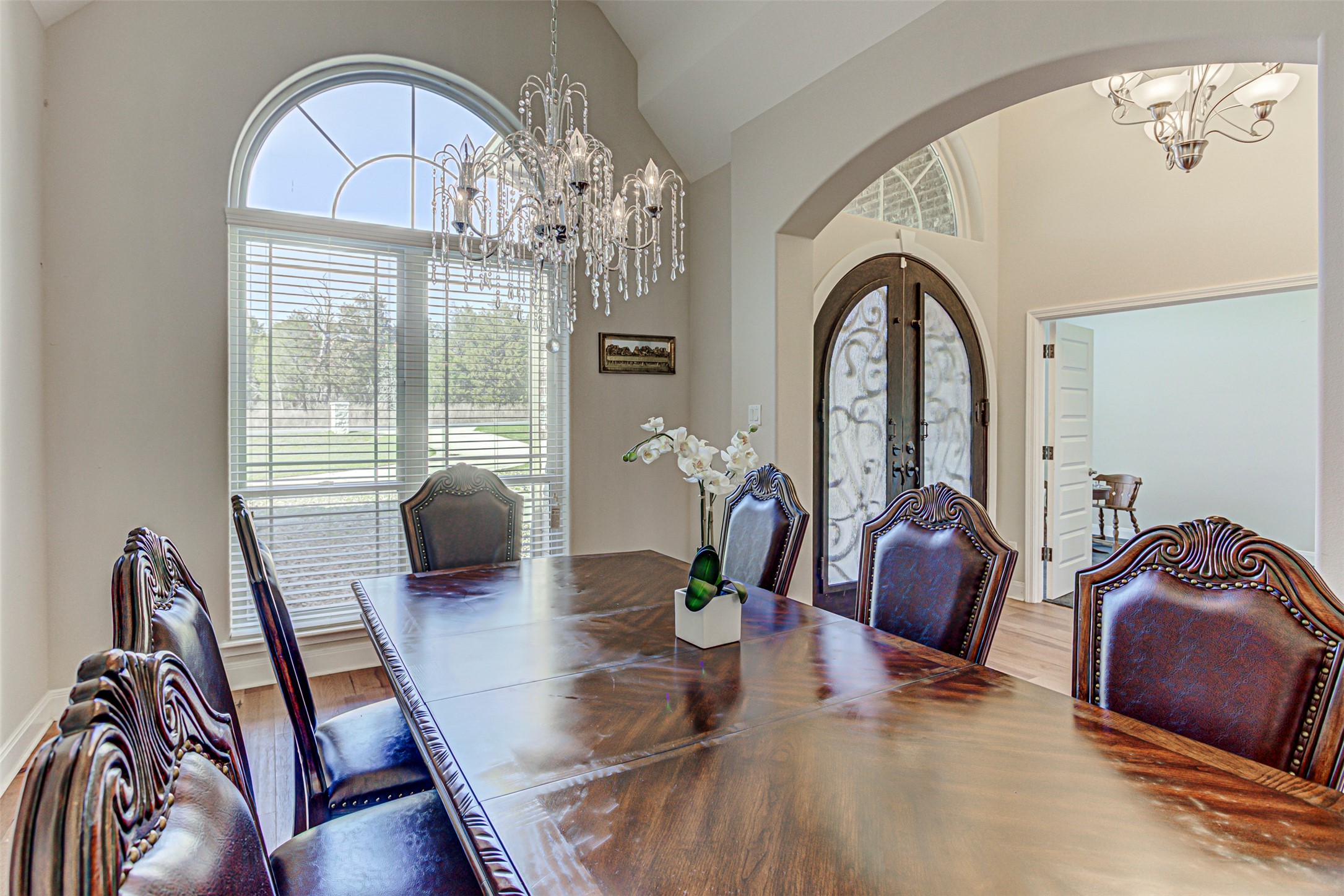 105 Arbors Circle Elgin, TX 78621 - Photo 6 of 40 Dining area featuring hanging lights, arched walkways, wood finished floors, plenty of natural light, and vaulted ceiling