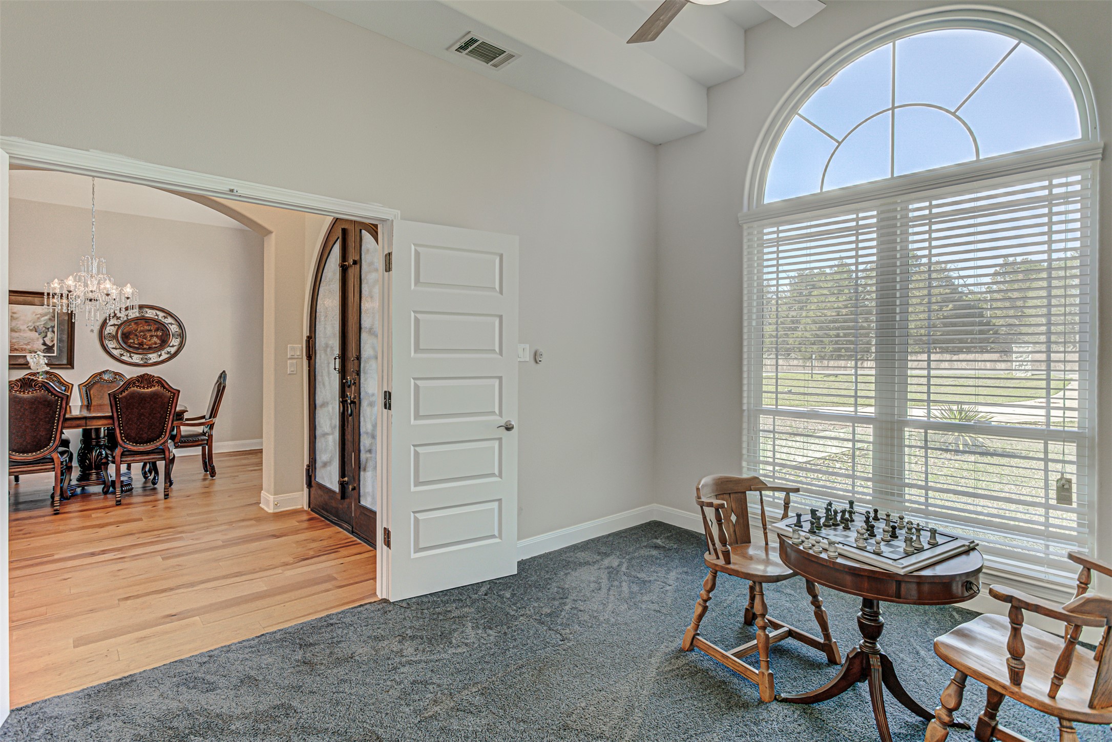 105 Arbors Circle Elgin, TX 78621 - Photo 8 of 40 Sitting room with hanging lights, light colored carpet, a ceiling fan, and arched walkways