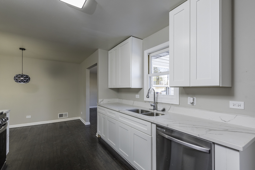 821 12th Street North Chicago, IL 60064 - Photo 11 of 25 a kitchen with a sink cabinets and window