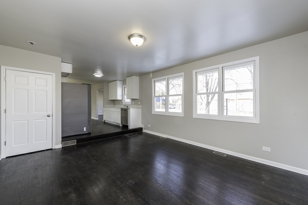 821 12th Street North Chicago, IL 60064 - Photo 13 of 25 an empty room with wooden floor and windows